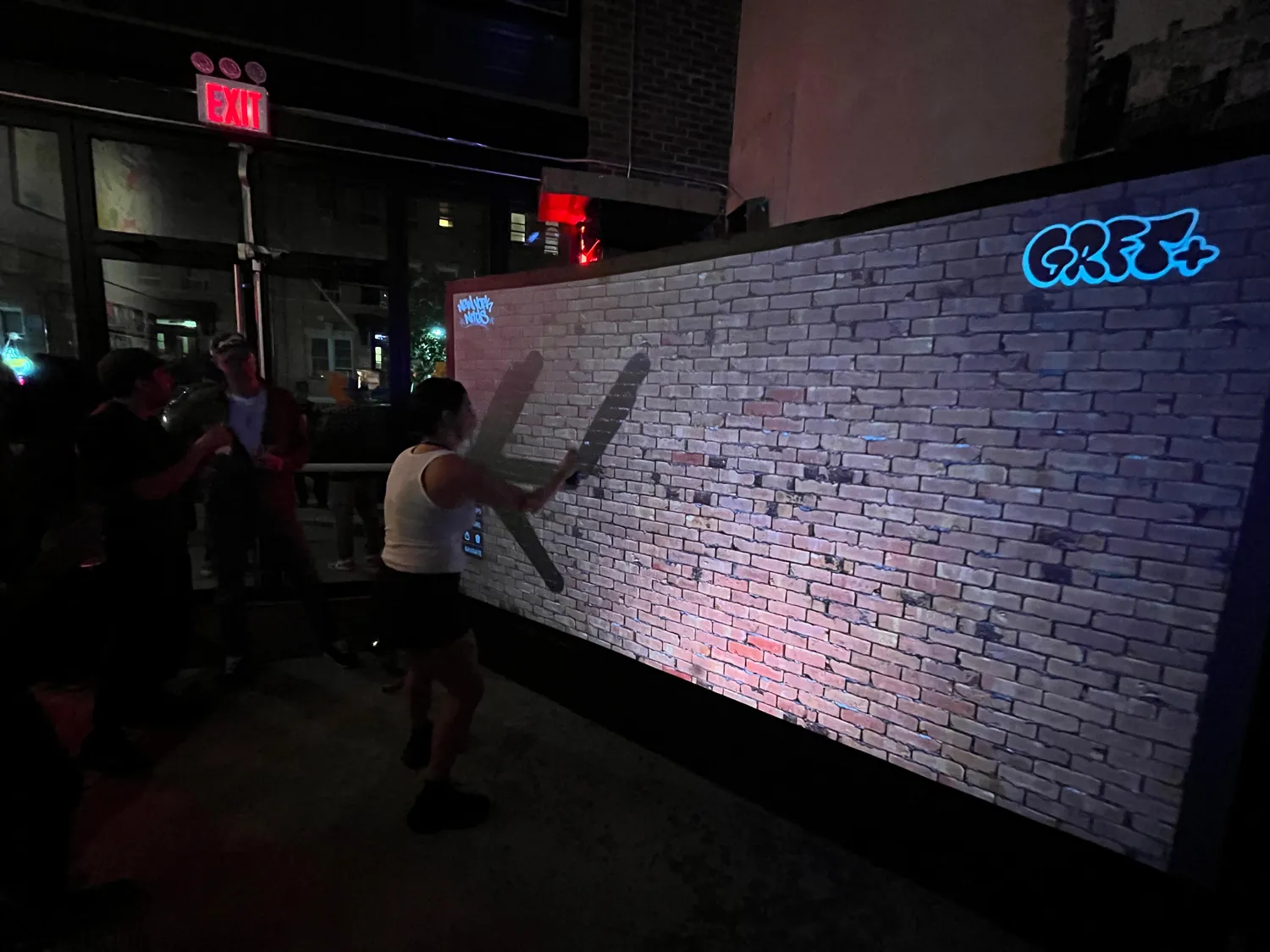 The Graffiti+ digital wall lit up in the room at New York Nites, Brooklyn