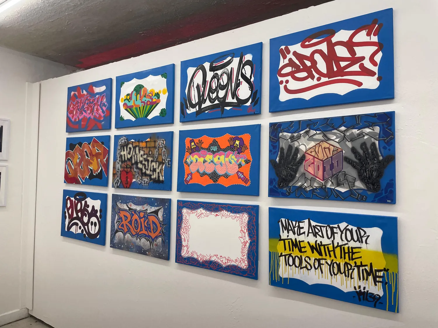 Original works lining the wall at the New York Nites art show