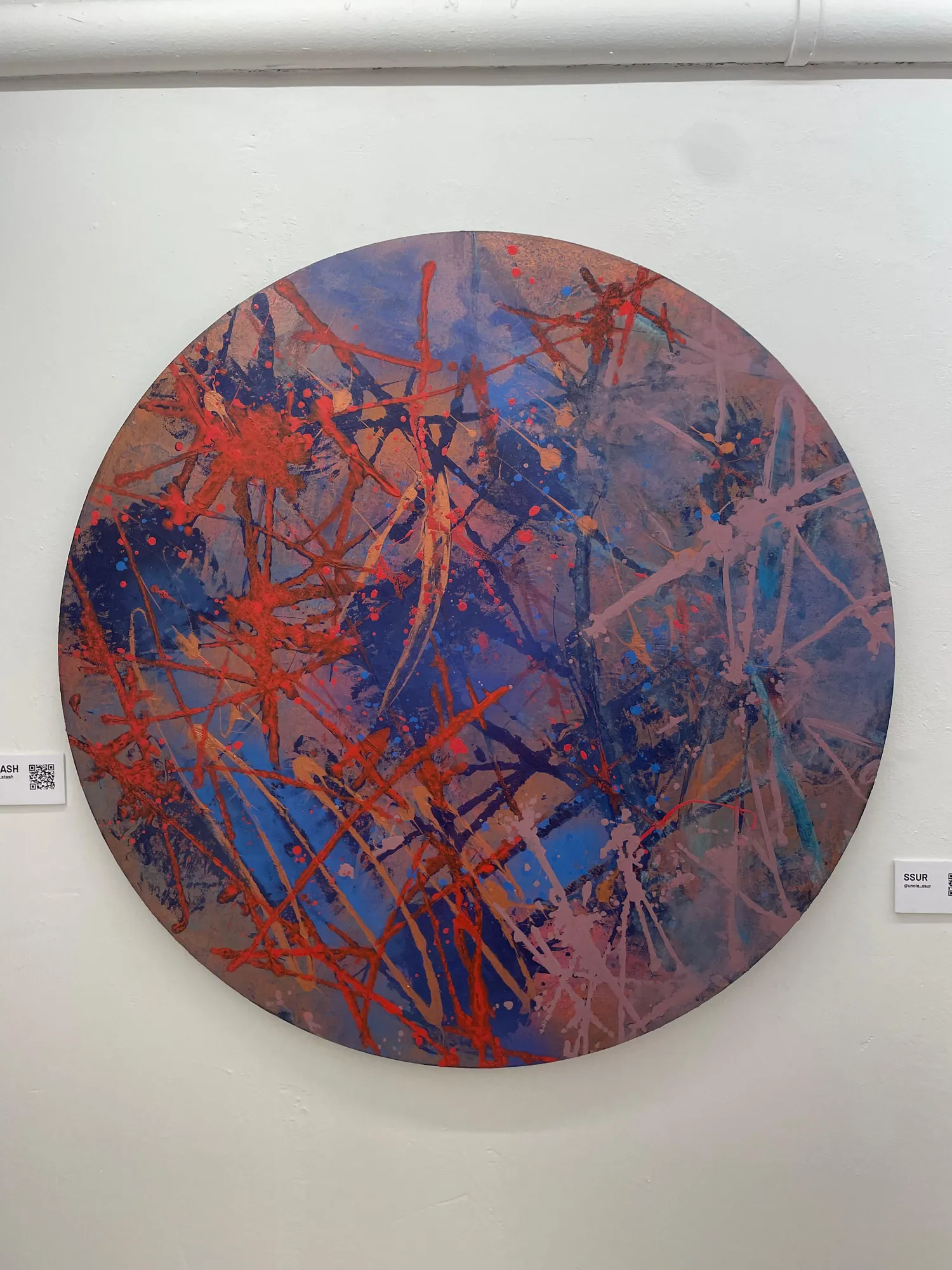 A circular painted piece on display