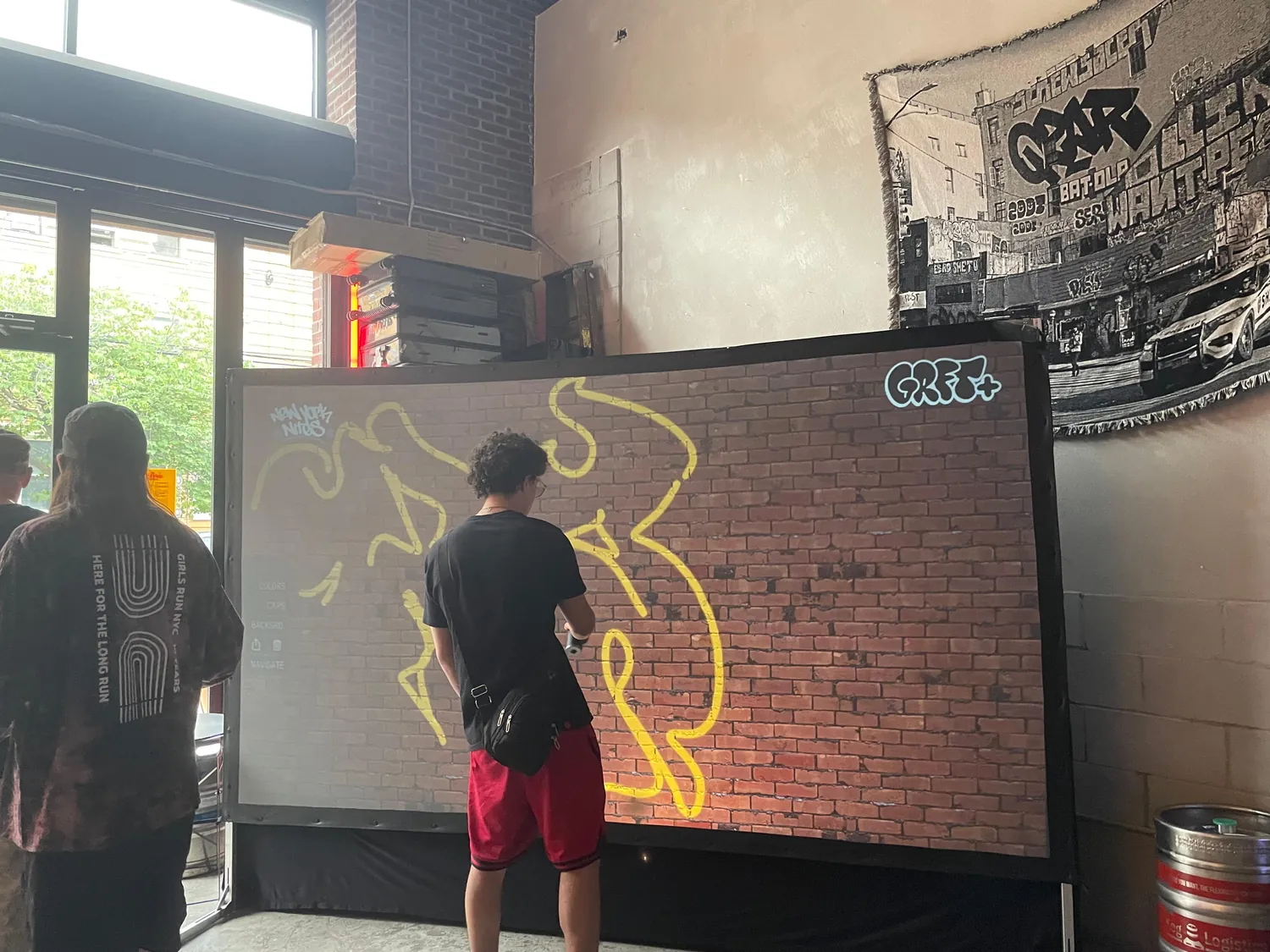 A guest stepping up to the wall, lit by the projection
