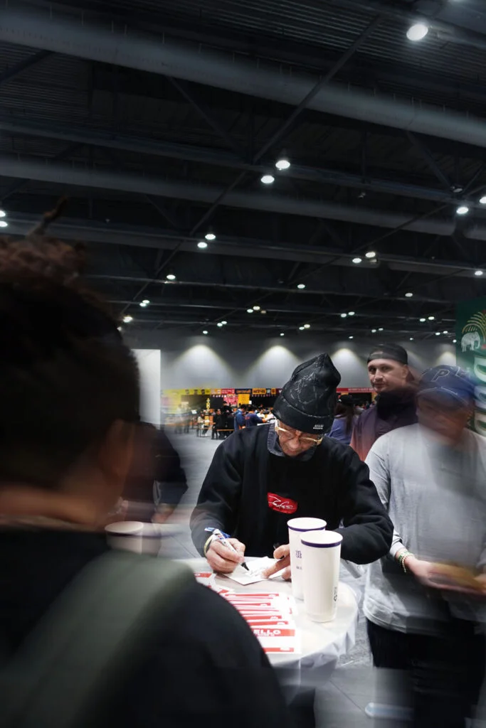 Graffiti legend Futura signing autographs at the Graffiti+ × Chairman Ting × Billion Buns 'Digital Graffiti Space Bun' booth at ComplexCon Hong Kong 2025