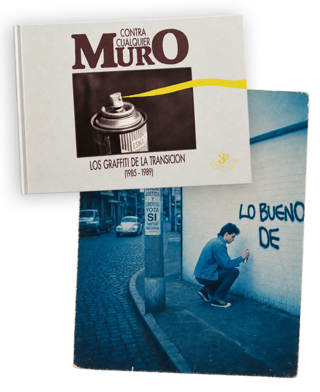 Founder holding the published graffiti book 'Contra Cualquier Muro — Los Graffiti de la Transición (1985–1989)' in front of a tagged wall