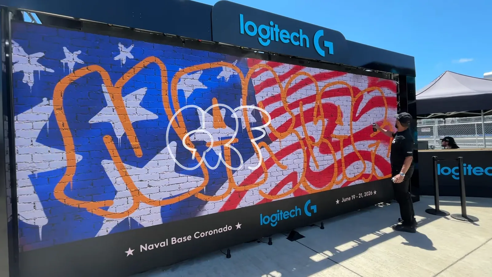 A finished stars-and-stripes graffiti piece with bubble lettering on the 8 by 16 foot Logitech LED wall at Naval Base Coronado, NASCAR San Diego 2026