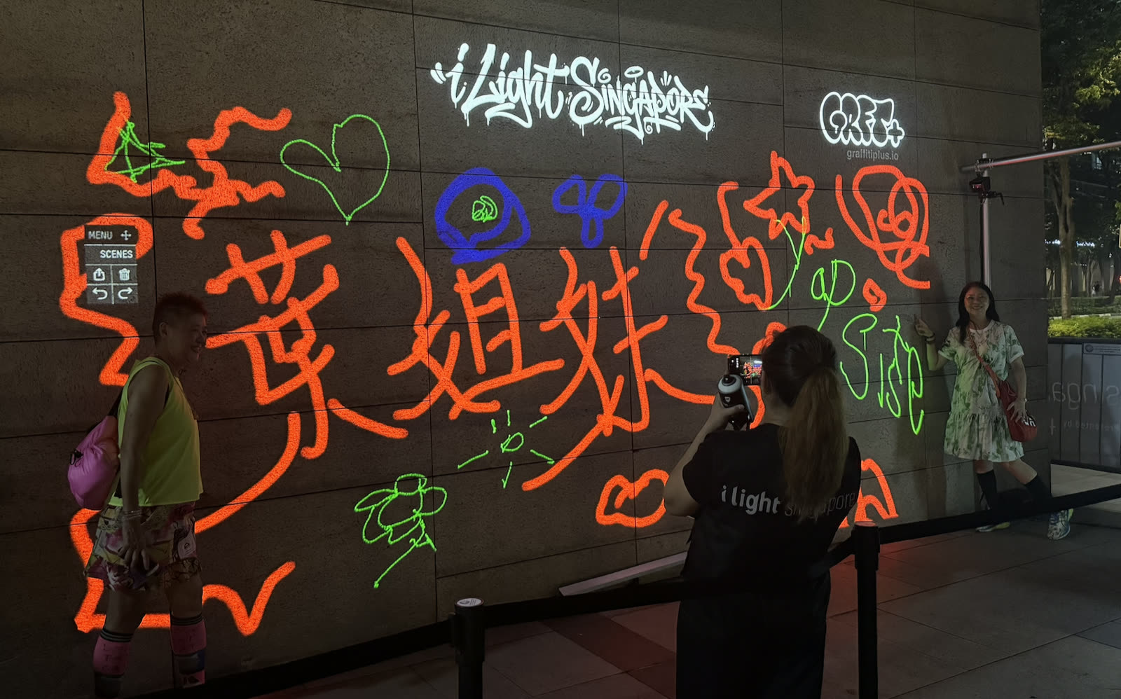 Families and visitors of all ages painting together on the Infinite Graffiti canvas