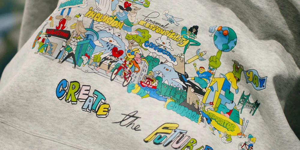 Detail of the custom-printed 'Create the Future' Lululemon hoodie — Chairman Ting illustration featuring keywords like Inclusion, Personal Responsibility, Connection, Courage and Equator