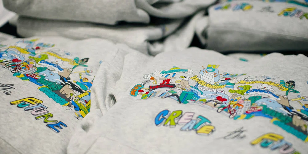 Stack of finished custom-printed 'Create the Future' Lululemon hoodies ready to be handed back to staff attendees as a take-home gift from the RMI Gathering 2023