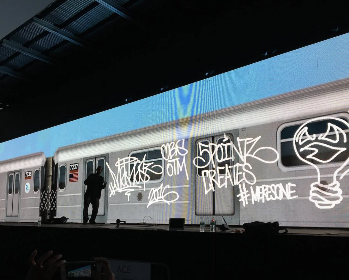 A full-size New York subway car (cars 7237 and 7238) tagged with '5Pointz Creates' and #MERESONE, projected across the 150-foot Graffiti+ LED wall at Panorama Festival 2016